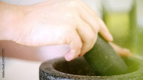 Wallpaper Mural Home cook using a pestle and mortar to crush coriander seeds into a powder. Pouring the powder into a black bowl.  Torontodigital.ca