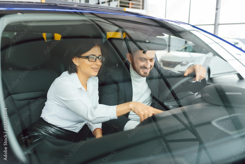 Young business people working together while traveling by a car.