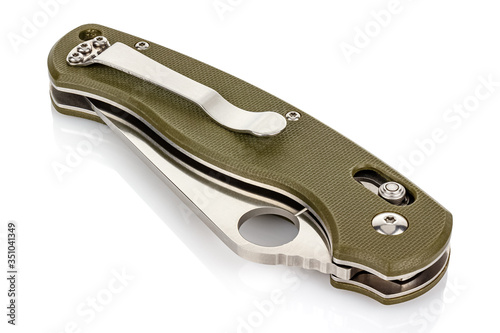 Closed folding pocket knife with textured dark green composite plastic cover plates on steel handle isolated on white background with reflection on glossy surface. Pocket knife close-up image