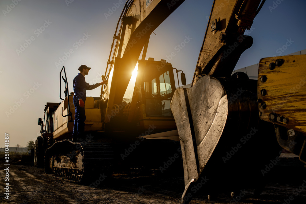 Fototapeta premium A contractor builder is sitting near bulldozer