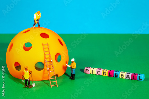 Pickleball Construction with miniature work men and play block lettering of PICKLEBALL