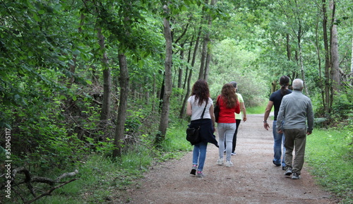 Famiglia che passeggia nel parco in primavera - relax e natura