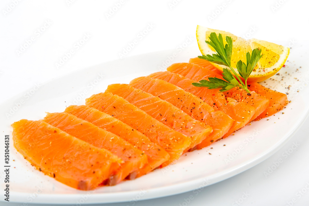 Salted salmon with butter and lemon. Plate on a white background Salted salmon with butter and lemon. Plate on a white background