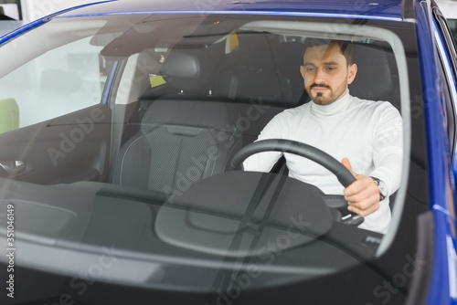 Attractive elegant happy man in good car