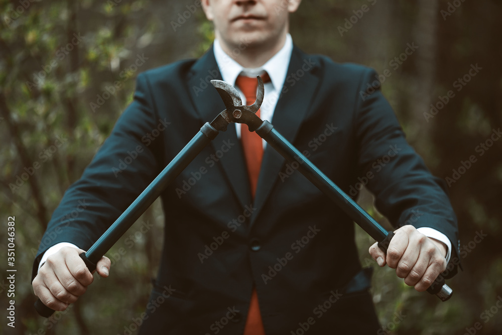 concept of a change of profession. A man holds a garden tool. secateur in hand. concept of a change of profession. A man holds a garden tool. secateur in hand.