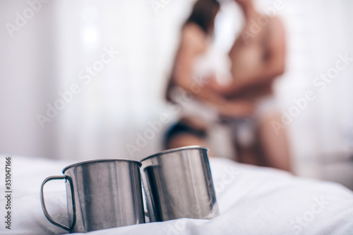 Fototapeta Naklejka Na Ścianę i Meble -  Couple in love. Love couple. Coffee cups. Love photo. Idea. Concept. Mug. Bedroom. Fashion photo. 