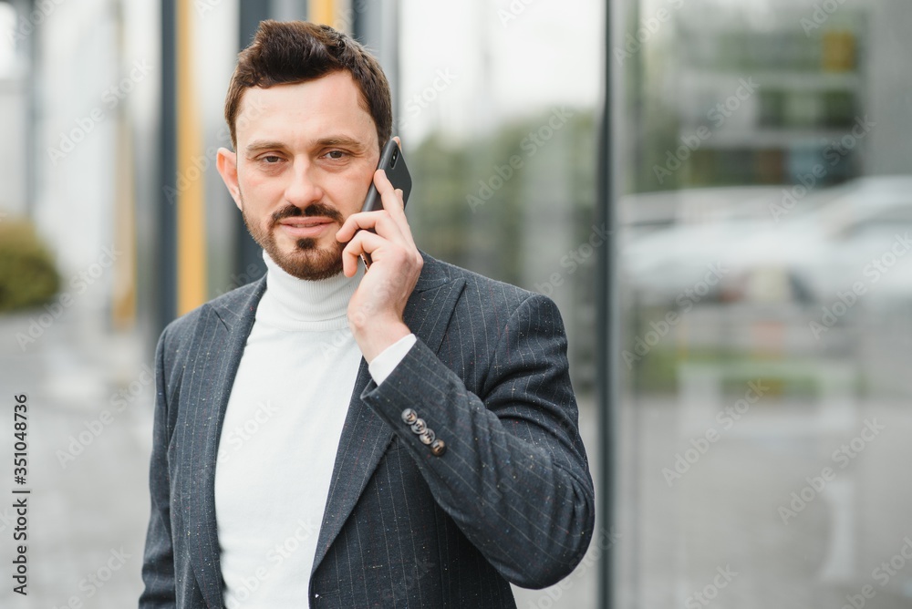 Confident executive manager having mobile talk concentrated on communication