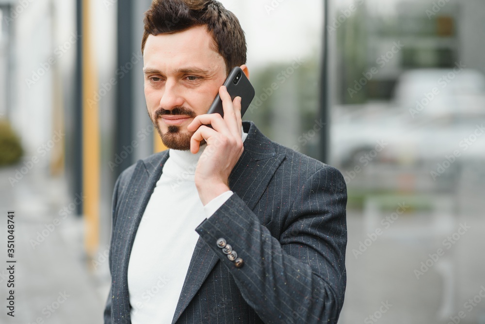 Confident executive manager having mobile talk concentrated on communication Confident executive manager having mobile talk concentrated on communication