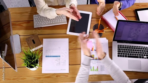 hands of business people coworkers working on wooden table from above, brainstorming team meeting, top view