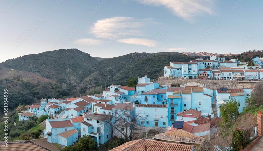 Aerial view of blue houses against the backdrop of rocky hills in Andalusia, Spain