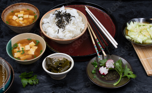 Vegan Japanese meal consisting of tofu miso soup, rice and cucumber salad