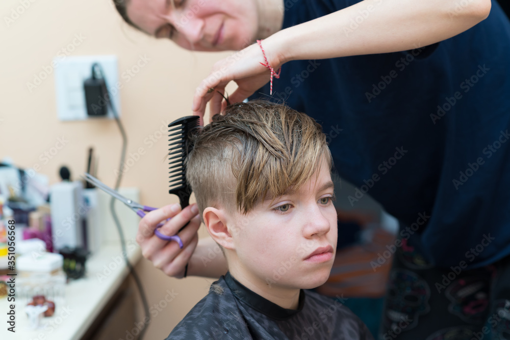 Mom cuts the hair of her son at home during quarantine amid COVID-19
coronavirus pandemic Mom cuts the hair of her son at home during quarantine amid COVID-19
coronavirus pandemic