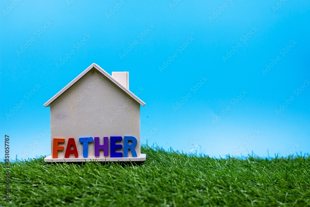 Happy Father's Day with word on house on green grass Happy Father's Day with word on house on green grass