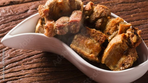 Delicious appetizer of fried pork crackling with smoke. Top view.