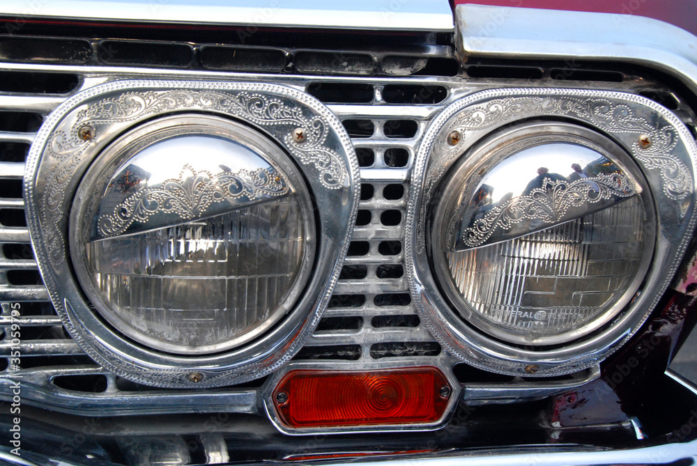 engraved chrome frame of headlight of custom american car