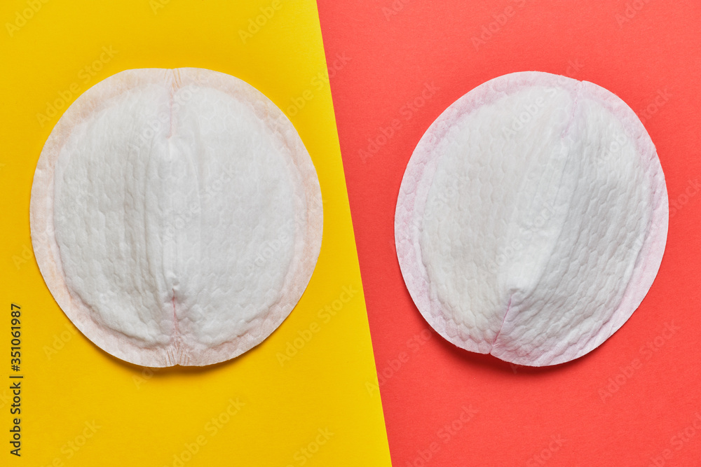 Women pad for bra on a yellow and red background. - obrazy, fototapety, plakaty 
