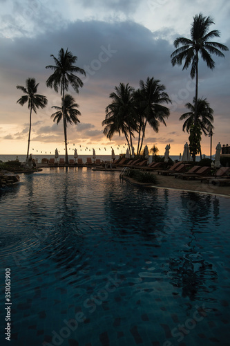 Palm trees on amazing tropical sea beach during sunset. © De Visu