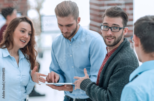 Business team with tablet pc computer having discussion in offic