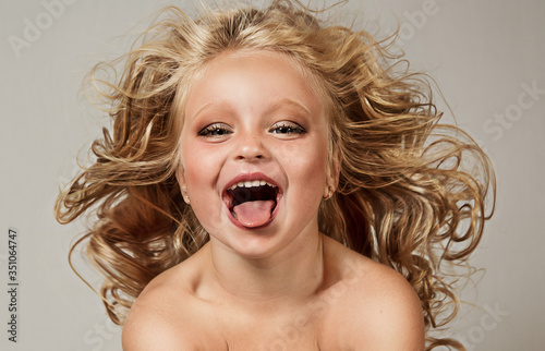 close up portrait of happy smiling blonde with flying hair