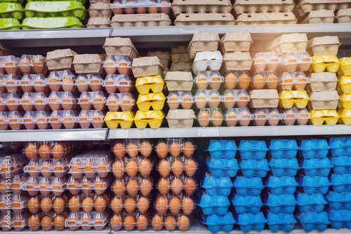 many eggs in the package are on the shelf of the supermarket. concept. close up front view