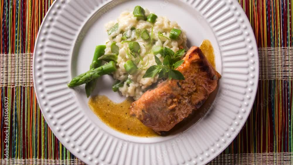 Asparagus risotto with grilled salmon. Top view with smoke. Asparagus risotto with grilled salmon. Top view with smoke.