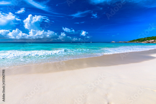 Turquoise waters of Grand Anse, La Digue, Seychelles. Grand Anse beach of Seychelles islands with copy space photo