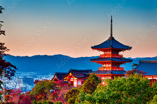 Japanese Heritage. Renowned Kiyomizu-dera Temple Pagoda Against Kyoto Skyline and Traditional Red Maple Trees in Background in Japan.