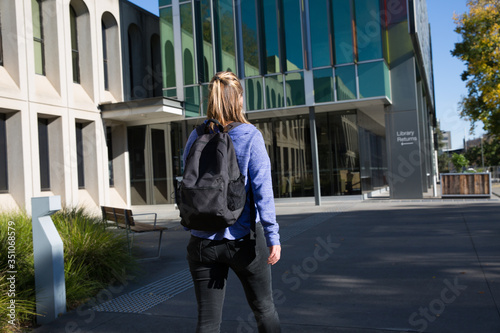 Student Walking Towards the Library Building