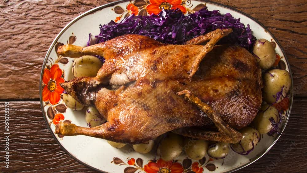 Roast duck with potatoes and purple cabbage. Top view with smoke.