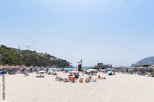 Beach with people and sea landscape in Camp de Mar, Majorca