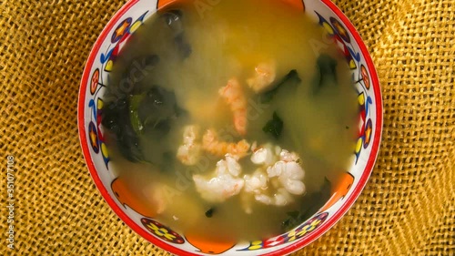 Tacaca is a specialty cuisine Amazon. Served in a natural bowl, tucupi boiling is poured over a gum made from tapioca flour. Top view with smoke.
