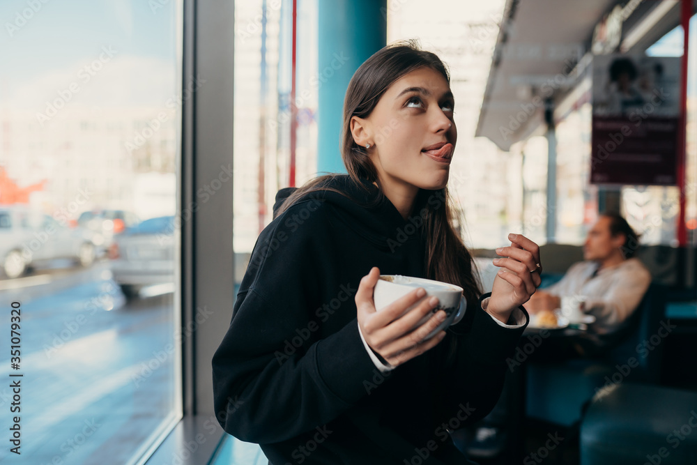 Close up portrait of pretty female drinking coffee. Close up portrait of pretty female drinking coffee.