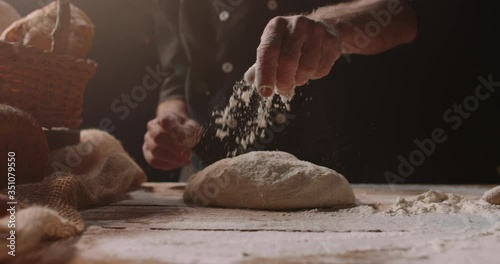 Professional mature caucasian baker forming loaf of bread dough with passion, retired pensioneer enjoying his new hobby, isolated on black background 4k footage photo