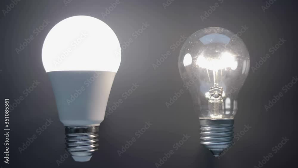 Energy-saving, eco-friendly Led bulb lamp compared to a classic glass tungsten filament lamp are lights up on a black background. Closeup Energy-saving, eco-friendly Led bulb lamp compared to a classic glass tungsten filament lamp are lights up on a black background. Closeup