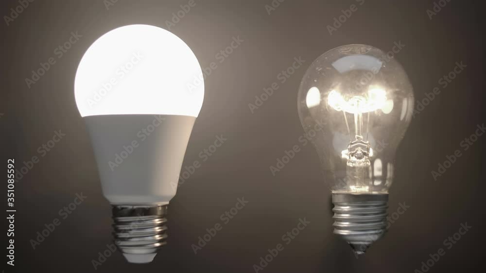 Energy-saving, eco-friendly Led bulb lamp compared to a classic glass tungsten filament lamp are lights up on a black background. Closeup