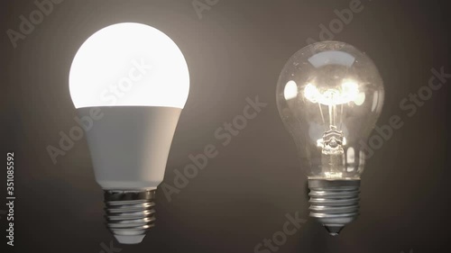 Energy-saving, eco-friendly Led bulb lamp compared to a classic glass tungsten filament lamp are lights up on a black background. Closeup