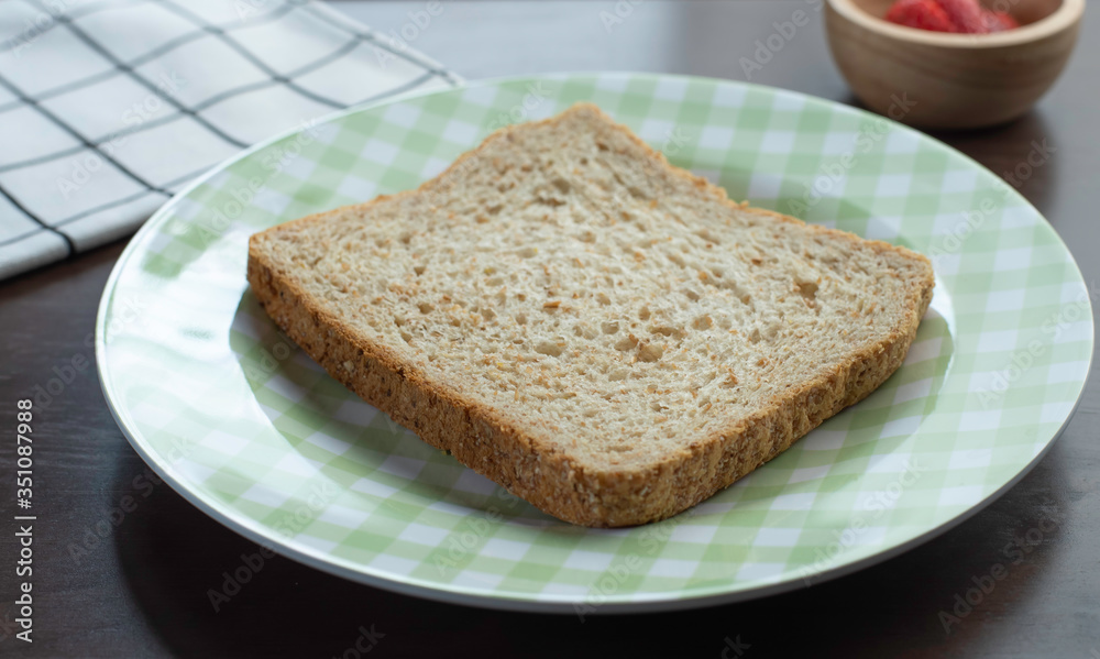 whole wheat bread in plate on wooden table for breakfast meal whole wheat bread in plate on wooden table for breakfast meal