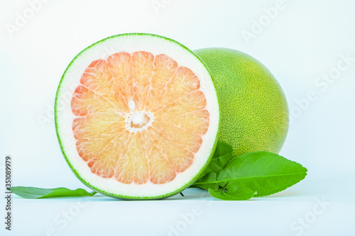 Thailand pomelo fruit isolated on white background, sweetie citrus fruit one cut in half with leaf