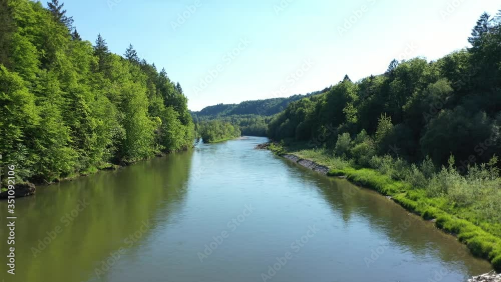 Drone flight video through Isar river next to Munich. Aerial view of Isar river near the Alps