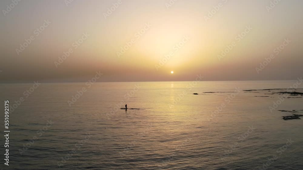 Fishermen standing in open sea water at sunset, Tripoli, Lebanon, forward aerial Fishermen standing in open sea water at sunset, Tripoli, Lebanon, forward aerial