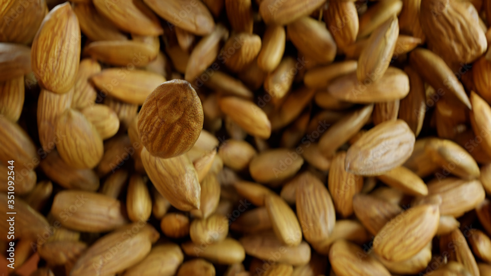 Almonds Explode Towards the Camera and Hang Floating in Air. Almonds Explode Towards the Camera and Hang Floating in Air.