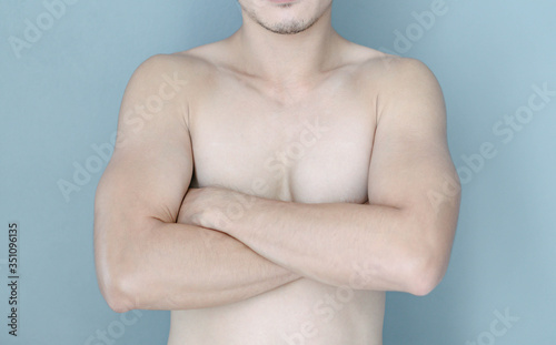 Closeup asian man crossed hand with blue background, health care concept