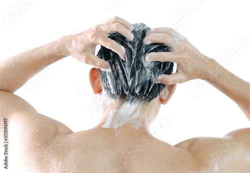 Closeup young man washing hair with shampoo isoleted on white background