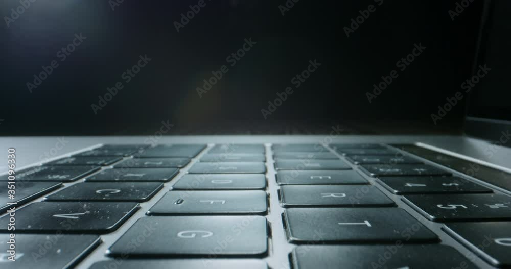 Close up zoom in shot of keyboard buttons of laptop computer, isolated on black background - technology, computers concept 4k footage