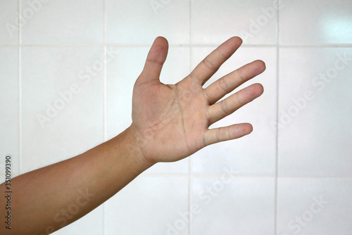 hand in a white wall background