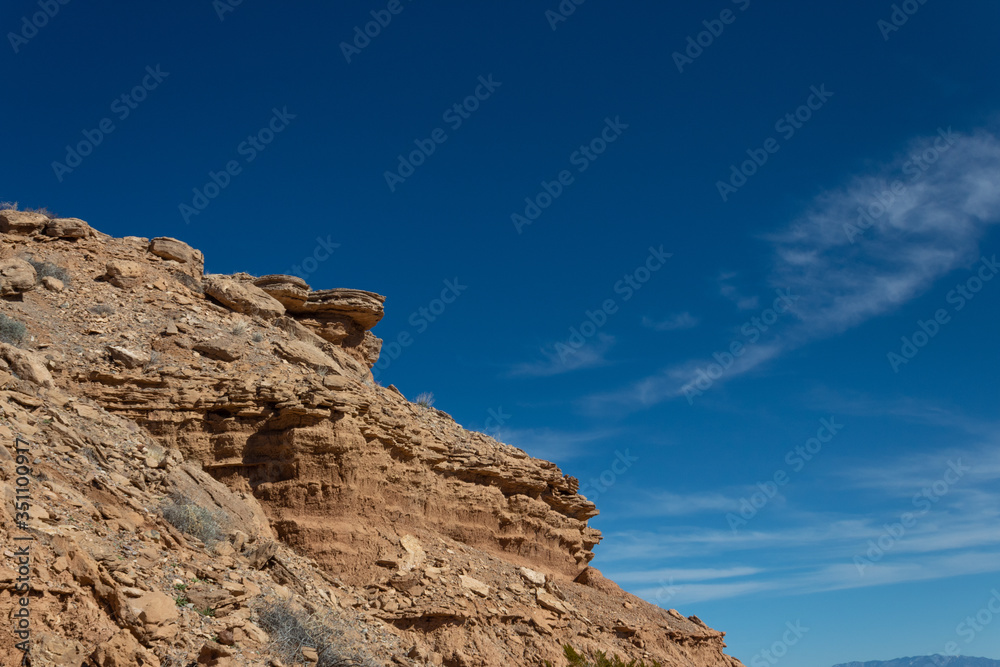 New Mexico USA rocky outcrop in desert mountain area, brilliant blue sky, horizontal aspect