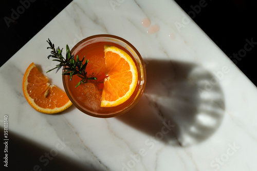 Overhead view of negroni cocktail served on marble table