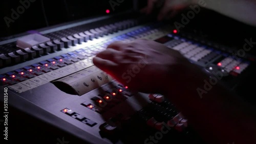 Lighting Technician Operating Lighting Board on a Concert photo