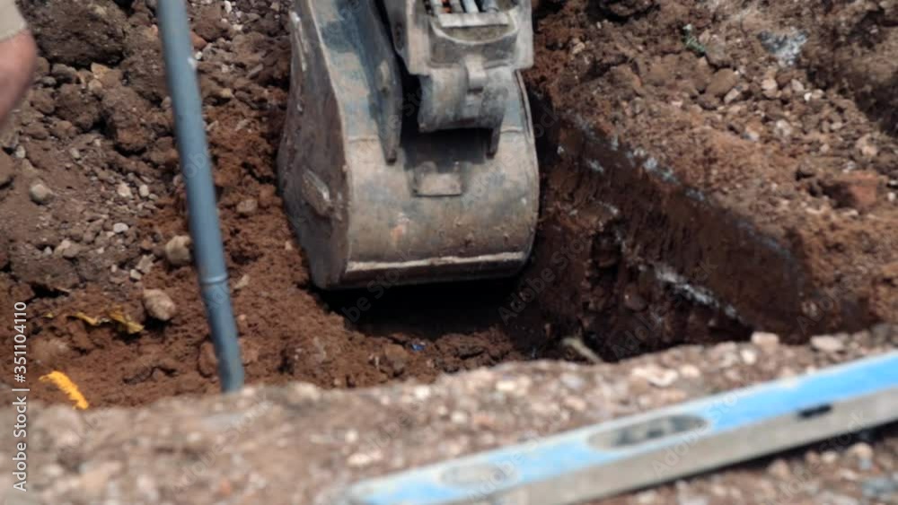 digger digging a hole on site