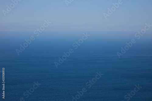blue sea and horizon in a haze